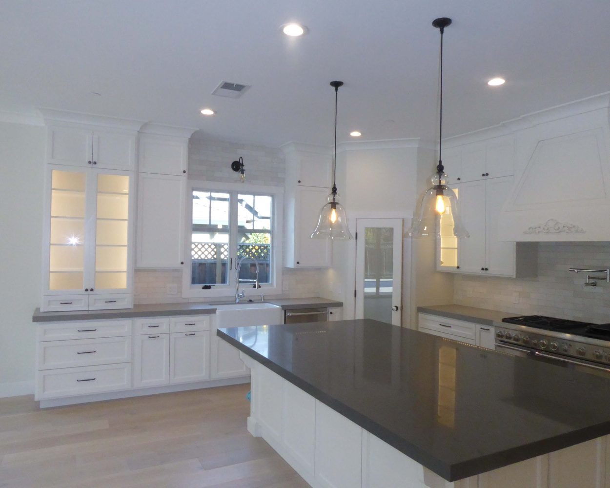 Bay Area kitchen remodel with black counter tops and white cabinets by Bay Area Design and Construction Company