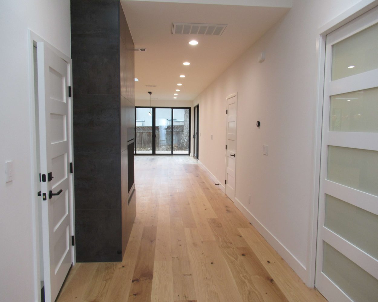 Long wood floored hallway by BAD&C remodeling contractors
